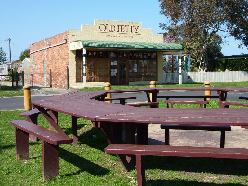 Tooradin - Landing Reserve picnic area fronting Sawtells Inlet, southern end of Foreshore Road: Tables at picnic area overlooking Old Jetty Cafe & Tearooms on Foreshore Rd
