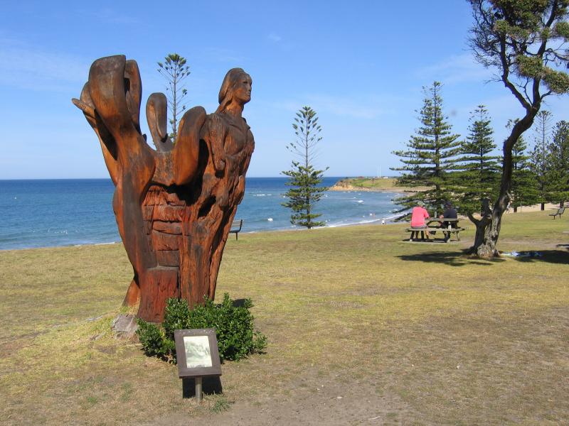 Torquay - Front Beach: Wood sculpture in old tree trunk, foreshore