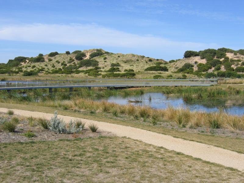 Torquay - Whites Beach: View south across lake towards sand dunes on coast, The Esplanade at Sands Bvd