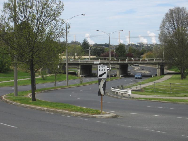 Traralgon - Around town: View south-east along Whittakers Rd under railway line with Loy Yang Power Station smoke stacks in background