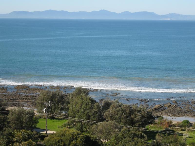 Walkerville - Bayside Drive as it descends down the coast: View south-east towards mountains of Wilsons Promontory
