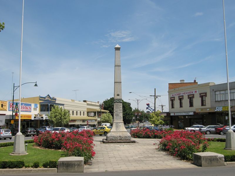 Warragul - Commercial centre and shops - War memorial, view south along Smith St and Victoria St at Williams St