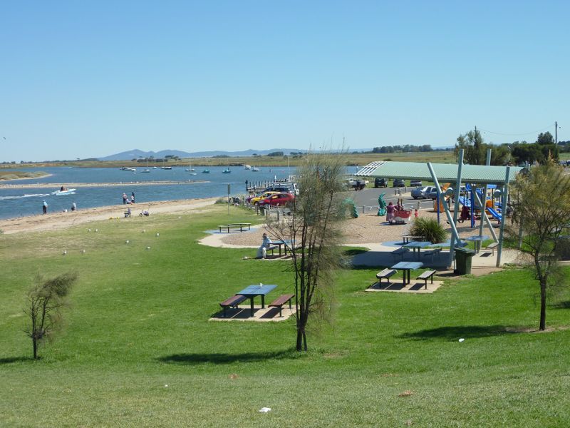 Werribee - Beach, foreshore, jetty, boat ramps and J.D. Bellin Reserve, Beach Road, Werribee South - Westerly view along Werribee River and foreshore towards BBQ shelter and playground