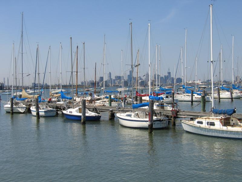 Williamstown - John Morley Reserve and Ferguson Street Pier - Boats moored at Ferguson Street Pier with city skyline in background
