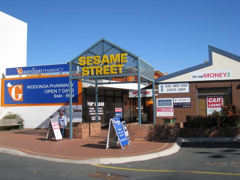 Wodonga - Shops along High Street south of railway line, Stanley Street and Woodland Grove: Sesame Street arcade at car park behind shops along eastern side of High St