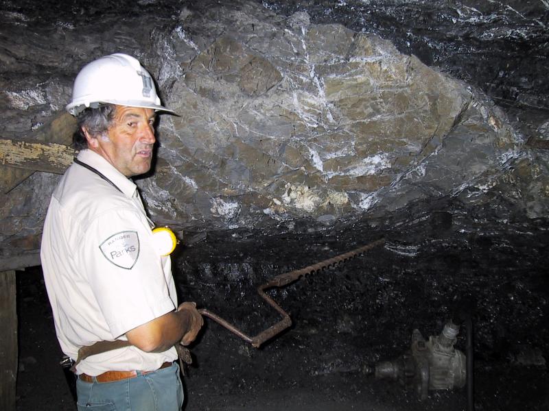 Wonthaggi - State Coal Mine Historic Reserve, East Area Mine, off Garden Street: The tourist guide demonstrates some mining tools