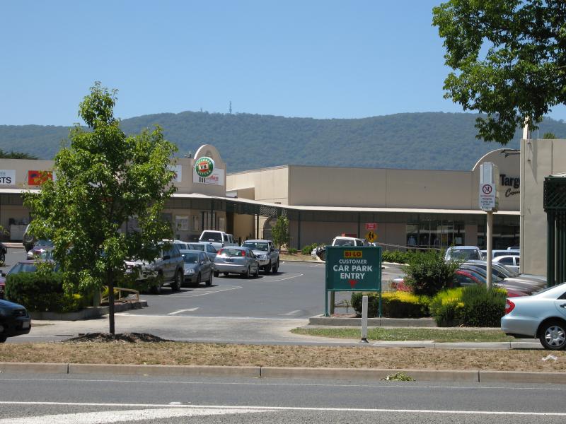 Woodend - Shops and commercial centre, High Street: View east through car park at 19th Hole Shopping Centre