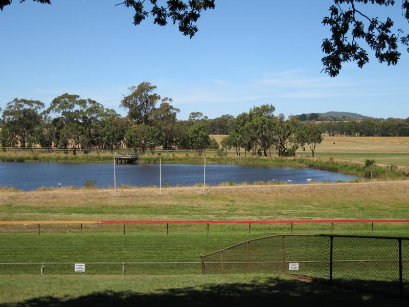 Woodend - Hanging Rock Reserve, South Rock Road: View east across dam in middle of racecourse